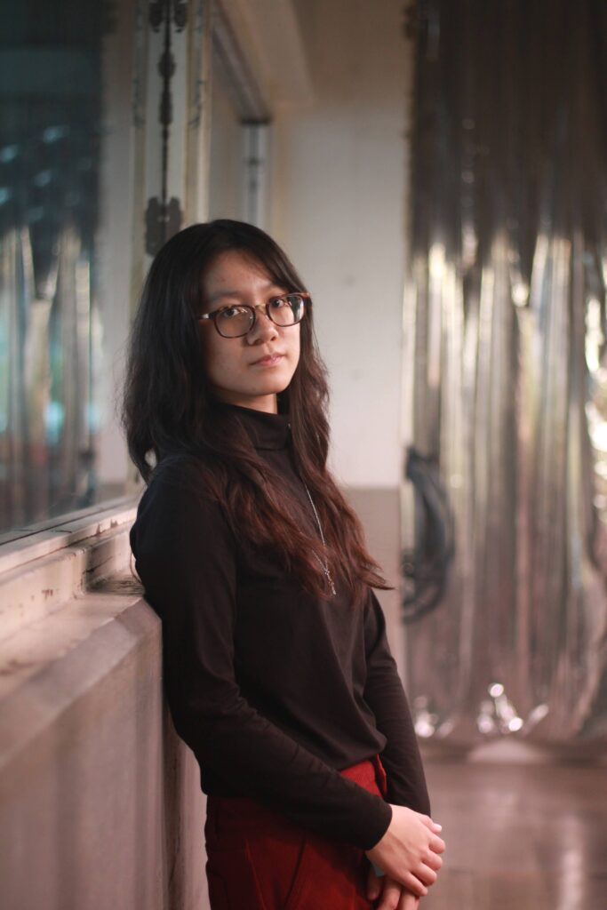 Girl leaning against windowsill